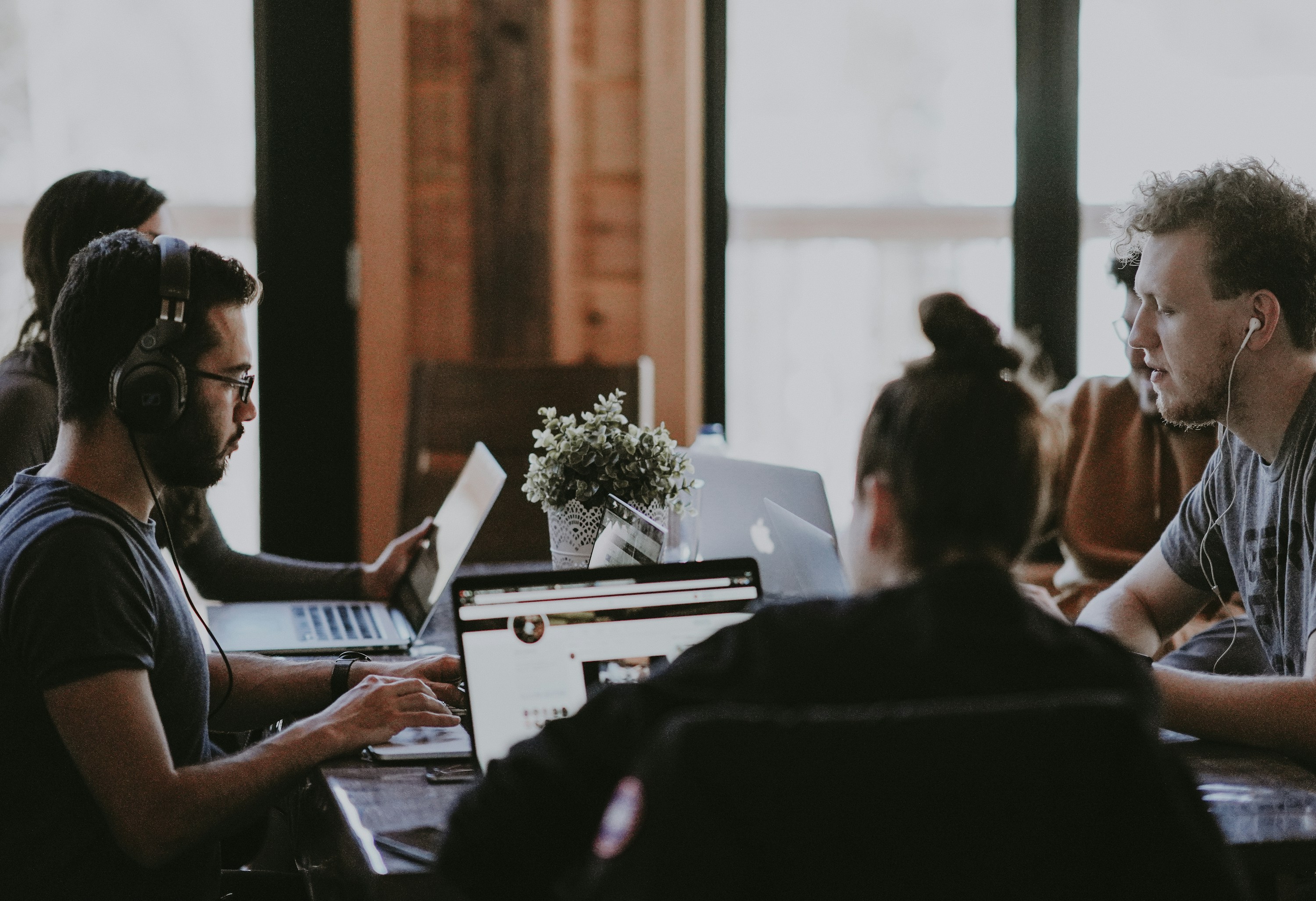 Software team discussing a technical project at a shared table