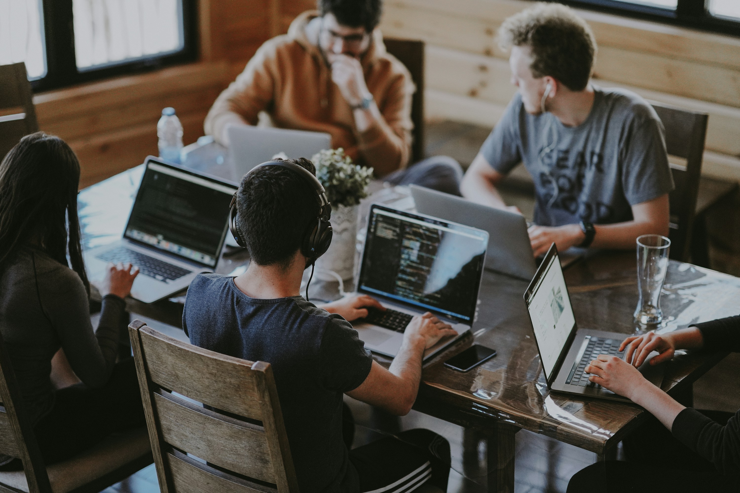Software professionals collaborating around laptops